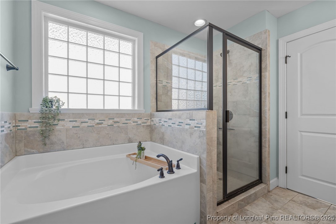 994 Micahs Way North Spring Lake, NC 28390 - Photo 21 of 42 a bathroom with a bathtub and a shower