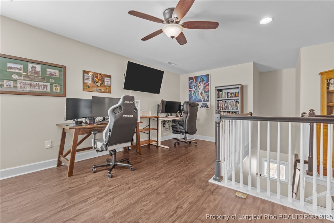 994 Micahs Way North Spring Lake, NC 28390 - Photo 23 of 42 a view of a workspace with wooden floor and a ceiling fan