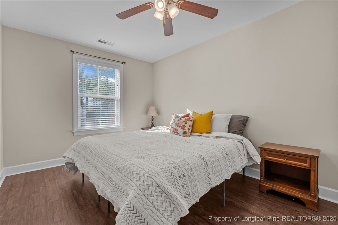 994 Micahs Way North Spring Lake, NC 28390 - Photo 26 of 42 a bedroom with a bed and a chandelier