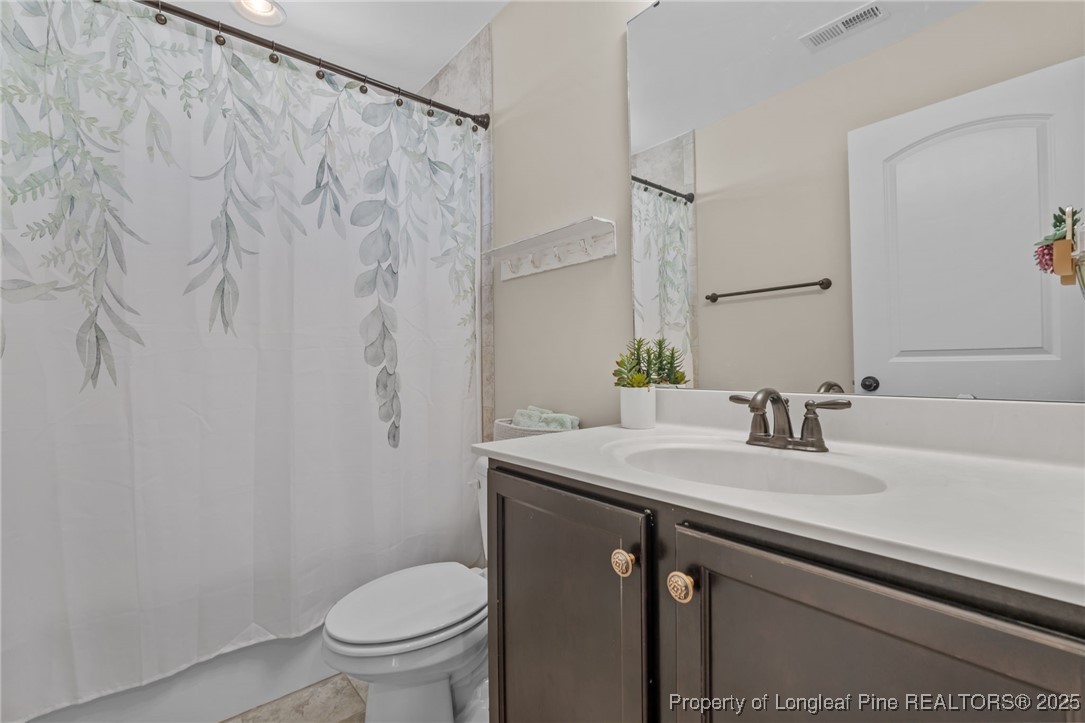 994 Micahs Way North Spring Lake, NC 28390 - Photo 28 of 42 a bathroom with a sink toilet and a mirror