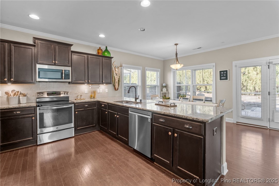 994 Micahs Way North Spring Lake, NC 28390 - Photo 10 of 42 a kitchen with stainless steel appliances granite countertop a sink stove and refrigerator