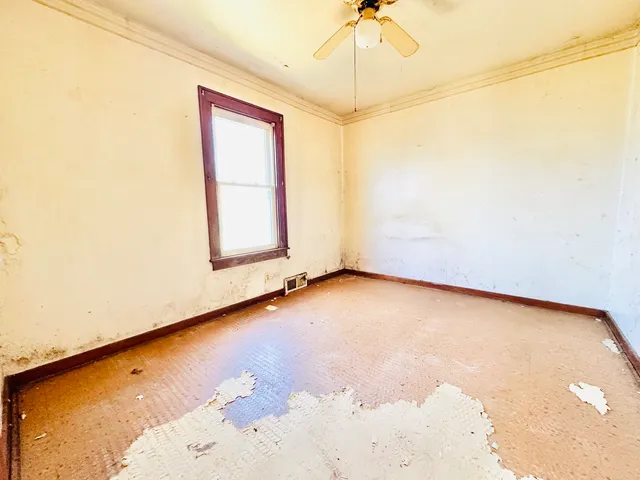 a view of an empty room and a window
