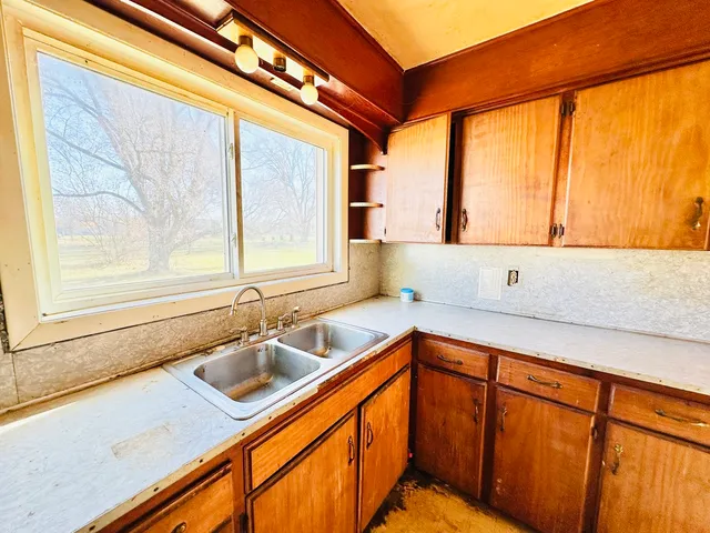 a kitchen with a sink and large window