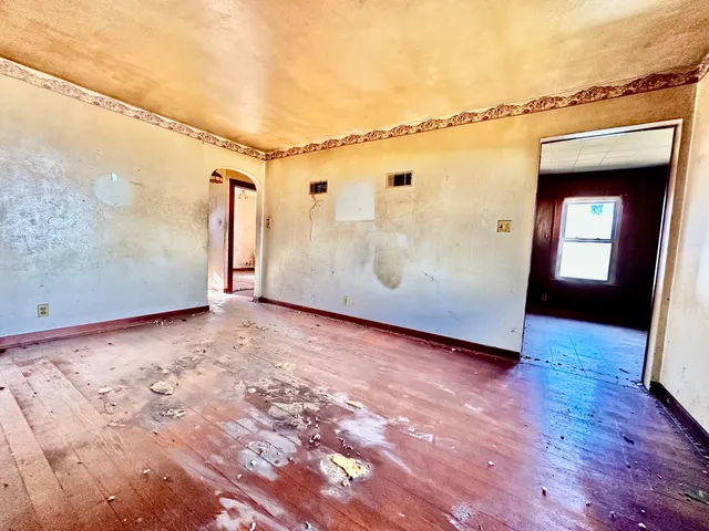a view of a room with wooden floor and windows