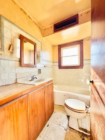 a bathroom with a sink a toilet and bathtub