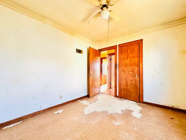 a view of a room with a ceiling fan