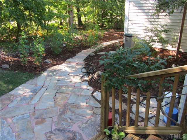 309 Russ Road Smithfield, NC 27577 - Photo 21 of 25 Stone walkway from front to rear of home - check out the flower beds!