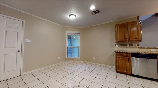 a view of kitchen with granite countertop cabinets