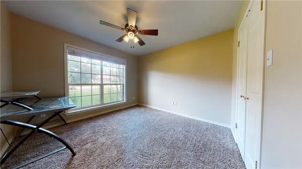 a view of room with workspace and windows