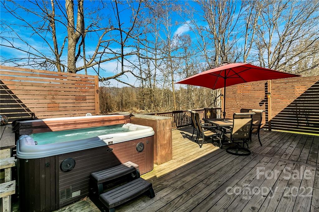 1470 Max Thompson Road Canton, NC 28716 - Photo 28 of 35 a view of a roof deck with table and chairs under an umbrella