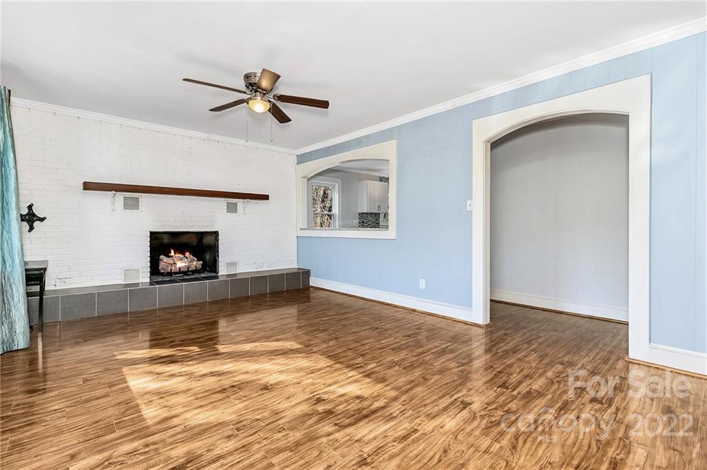 1470 Max Thompson Road Canton, NC 28716 - Photo 7 of 35 a view of empty room with wooden floor and fireplace