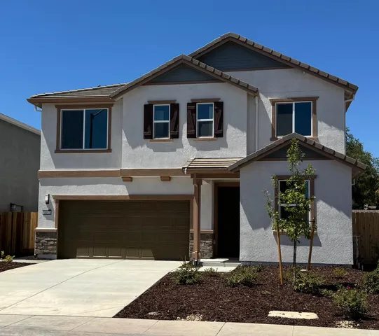 a front view of a house with yard
