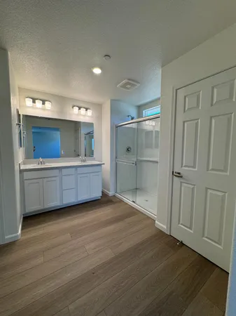 a view of a room with wooden floor and cabinet