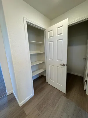 a view of walk in closet with empty racks