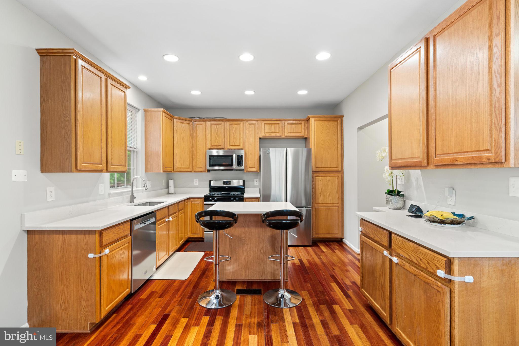 21654 Frame Square Broadlands, VA 20148 - Photo 11 of 43 Modern kitchen with warm wood accents.