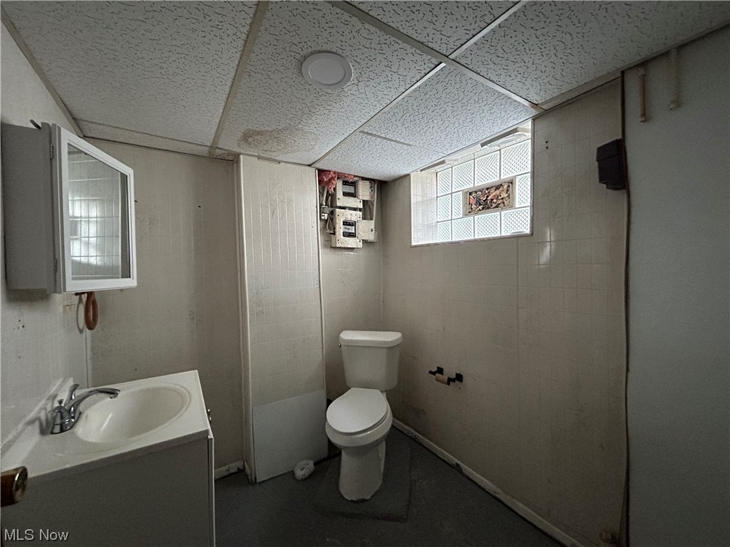 13604 Claiborne Road Cleveland, OH 44112 - Photo 13 of 18 Bathroom featuring a drop ceiling and vanity