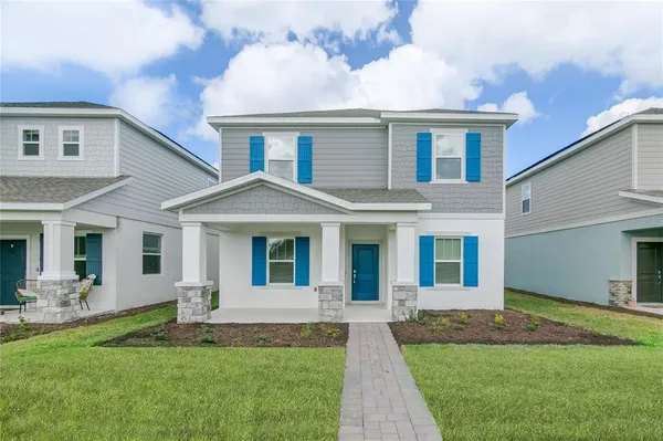 a front view of a house with a yard and porch