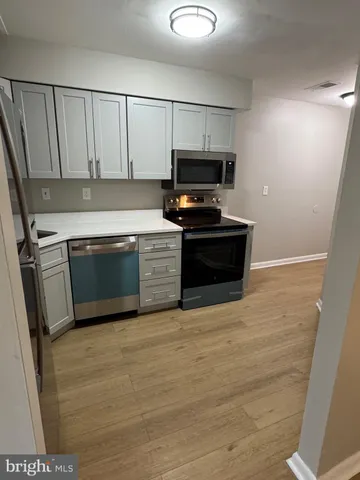 a view of kitchen with microwave and stove