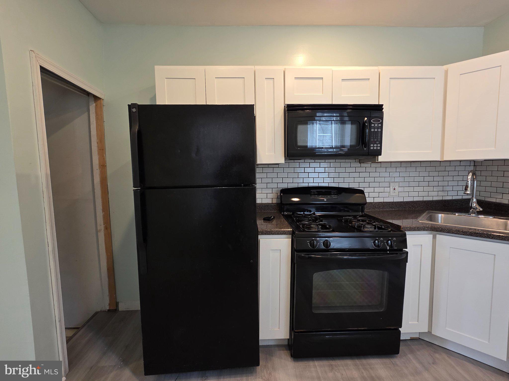 1864 North Uber Street Philadelphia, PA 19121 - Photo 7 of 29 Modern kitchen with sleek appliances.