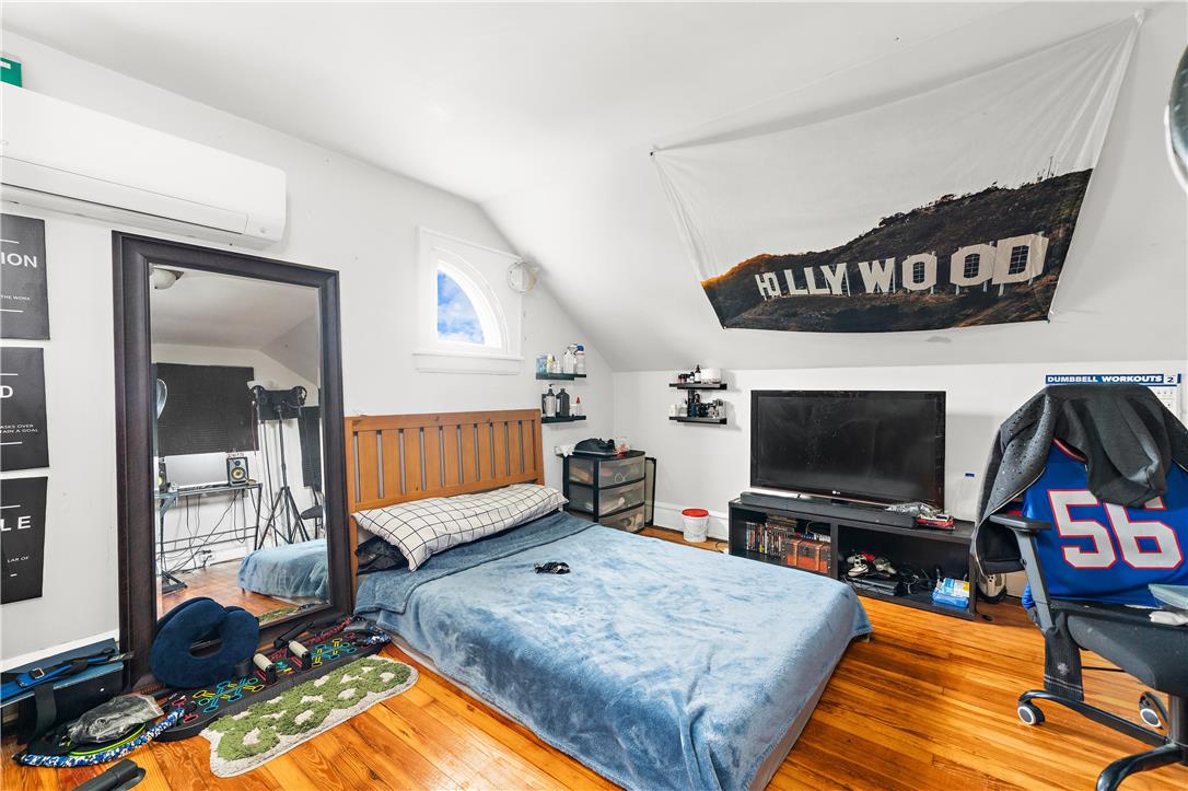 2055 Ferry Street Wilson, PA 18042 - Photo 18 of 21 This cozy bedroom features warm hardwood flooring and an inviting arched window.
