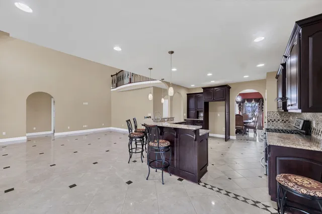 a large kitchen with a table and chairs in it