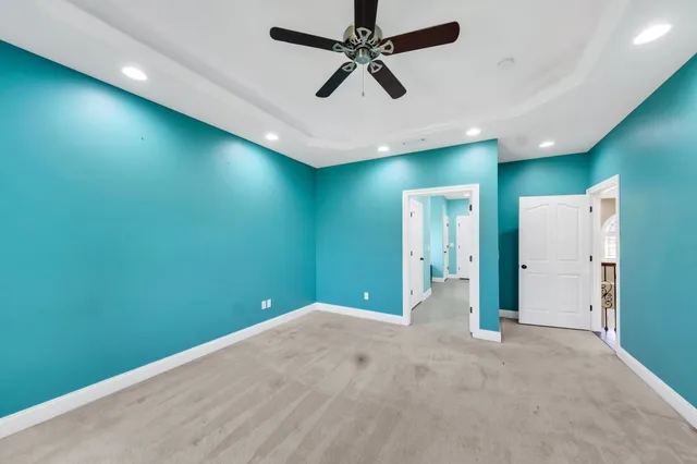 an empty room with closet and windows