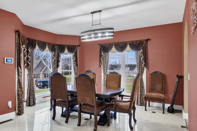 a view of a dining room with furniture and chandelier