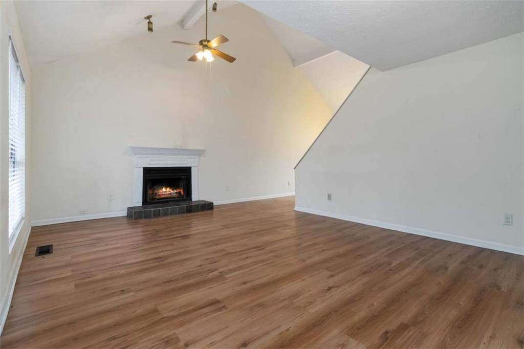 5552 Little Mill Road Buford, GA 30518 - Photo 11 of 30 a view of empty room with wooden floor and fireplace