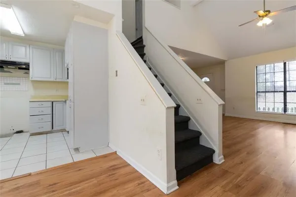 a view of a kitchen with wooden floor and staircase
