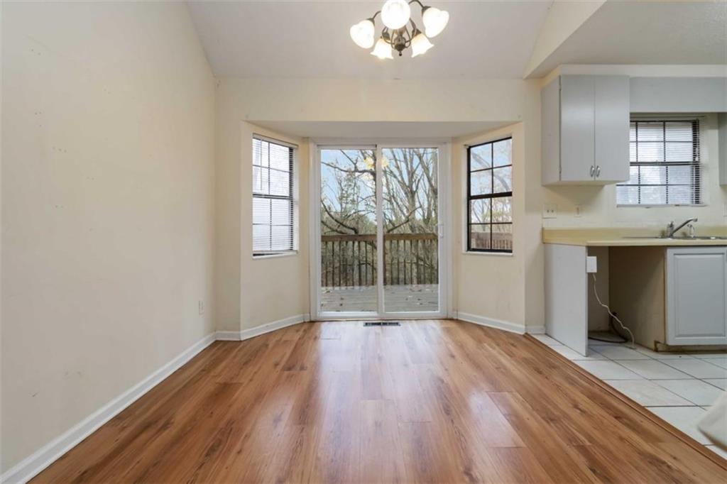 5552 Little Mill Road Buford, GA 30518 - Photo 15 of 30 an empty room with wooden floor and windows