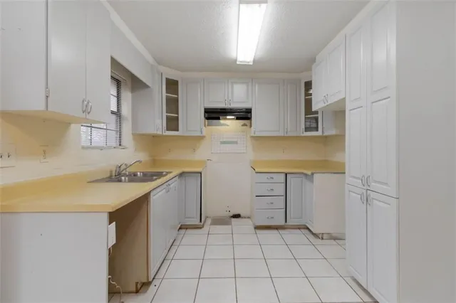 a kitchen with a sink a stove and cabinets