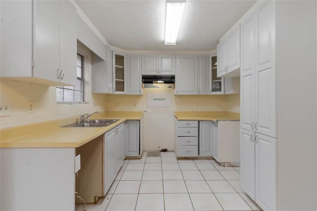 5552 Little Mill Road Buford, GA 30518 - Photo 16 of 30 a kitchen with a sink a stove and cabinets