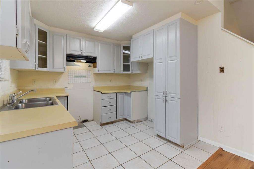 5552 Little Mill Road Buford, GA 30518 - Photo 17 of 30 a kitchen with cabinets and steel appliances