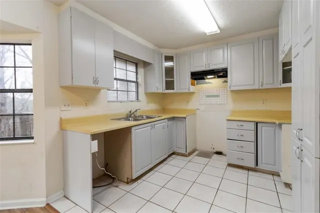 a kitchen with cabinets appliances and a window
