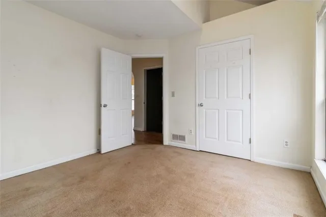 a view of an empty room with closet area