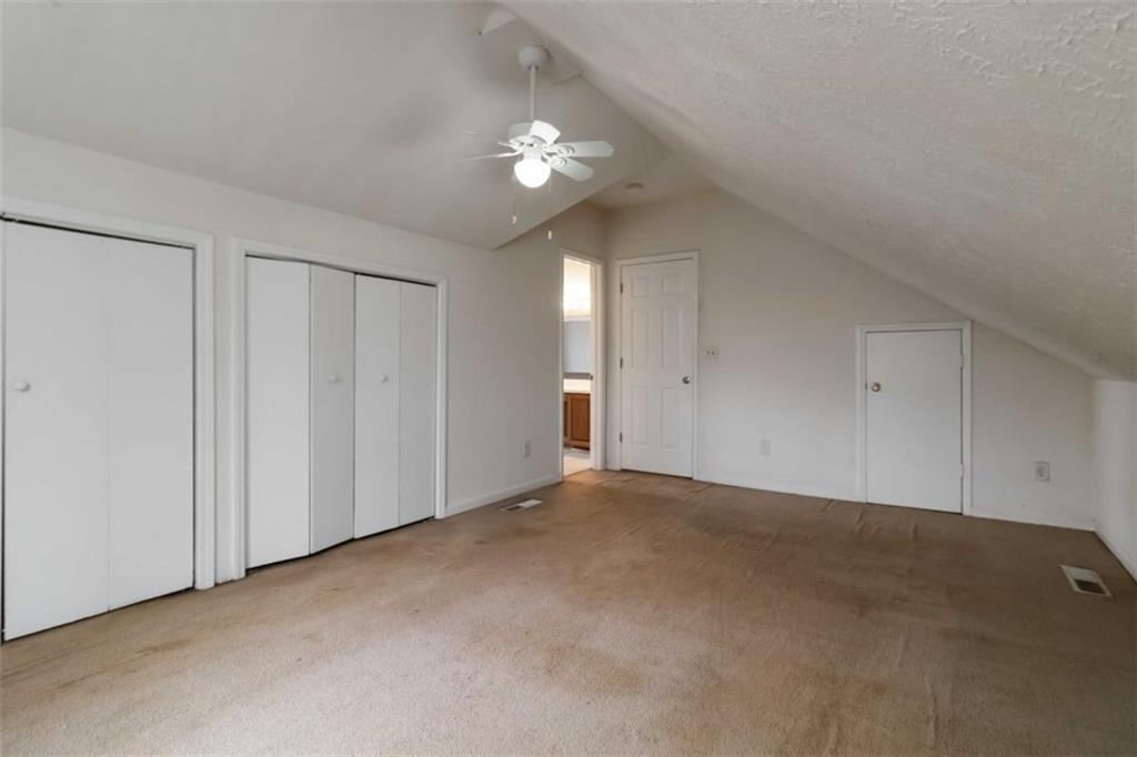 5552 Little Mill Road Buford, GA 30518 - Photo 25 of 30 a view of an empty room with a chandelier fan