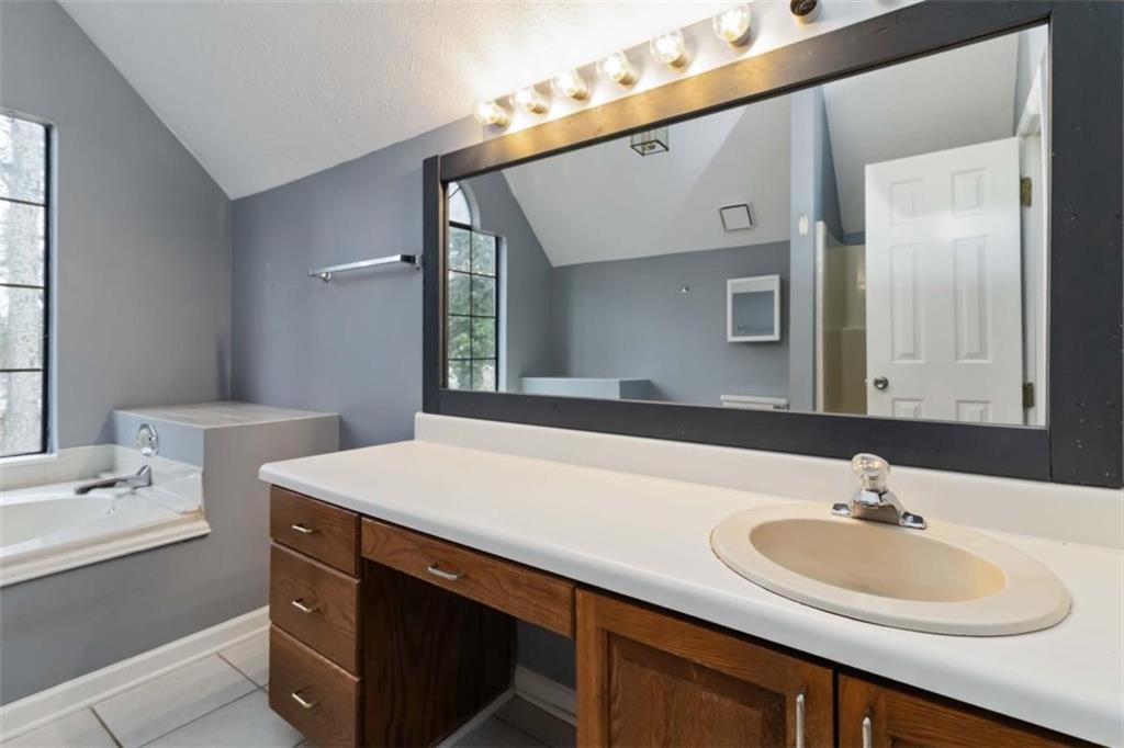5552 Little Mill Road Buford, GA 30518 - Photo 26 of 30 a bathroom with a sink and a mirror