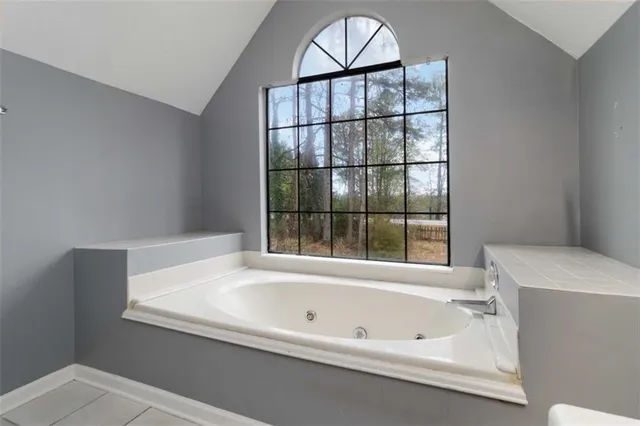 a bathroom with a bathtub and window