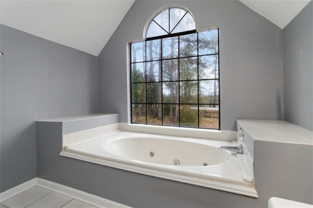 5552 Little Mill Road Buford, GA 30518 - Photo 27 of 30 a bathroom with a bathtub and window
