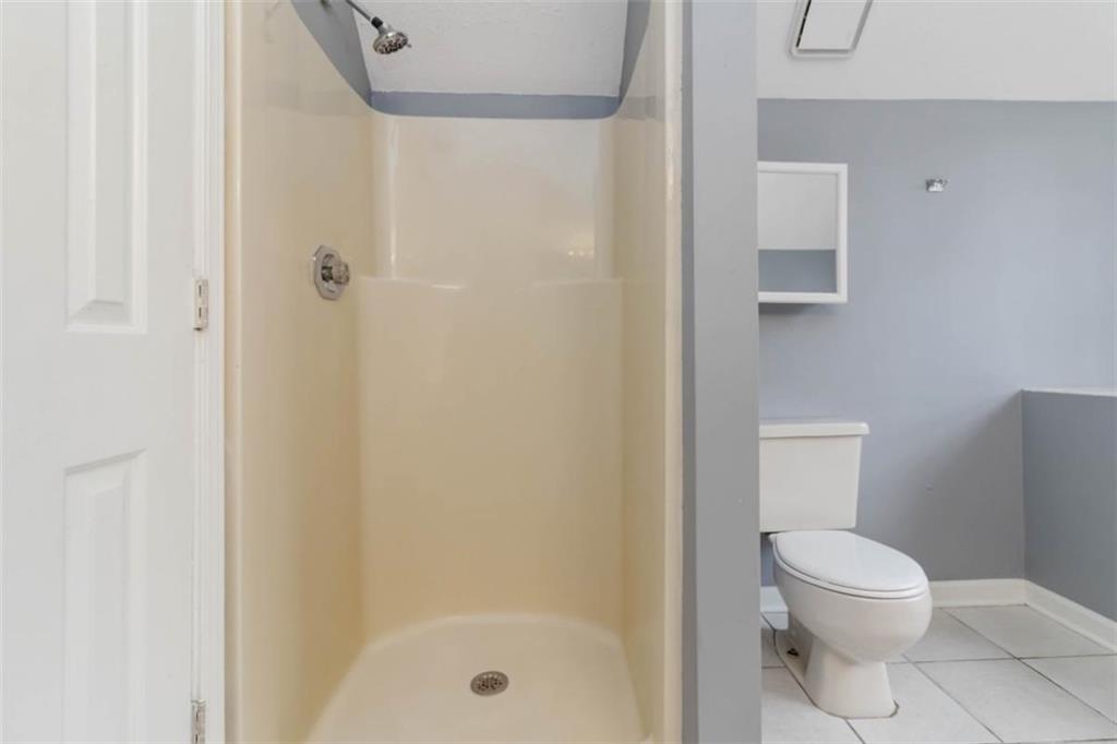 5552 Little Mill Road Buford, GA 30518 - Photo 28 of 30 a white toilet sitting next to a bath tub