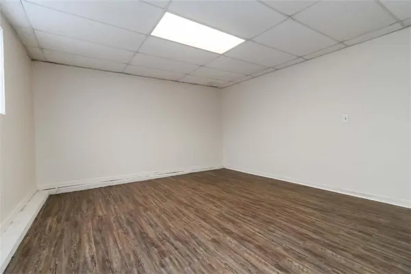 a view of an empty room and wooden floor
