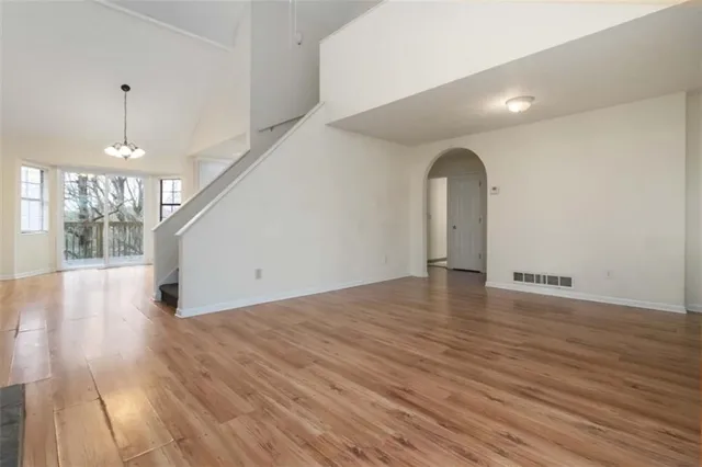 a view of a room with wooden floor and a chandelier