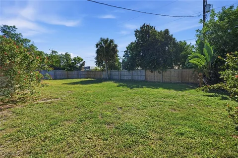 a swimming pool with outdoor seating and yard