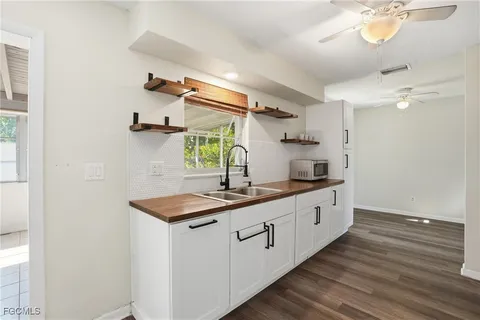 a kitchen with sink cabinets and wooden floor