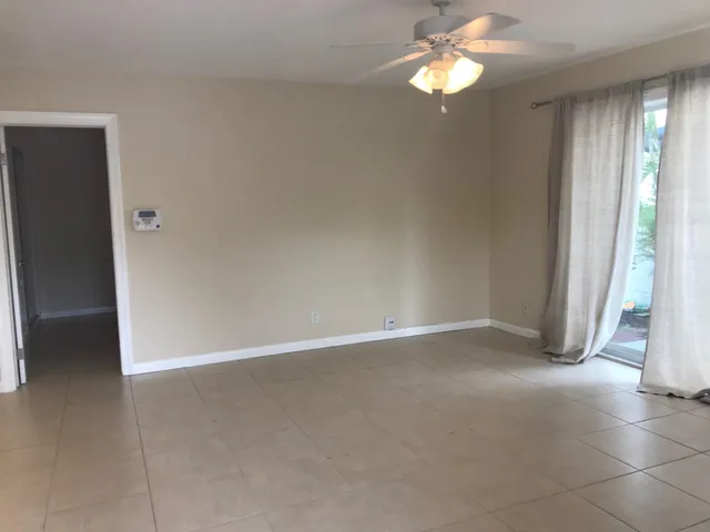 an empty room with closet and windows