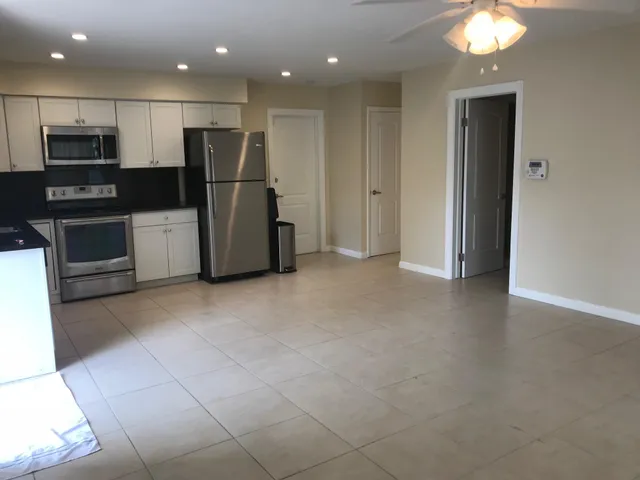 a view of a kitchen with a sink and stainless steel appliances