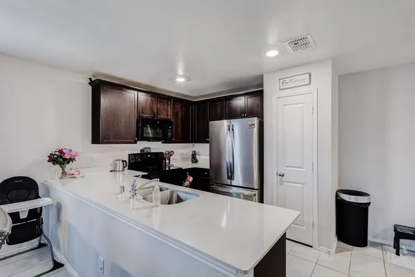 a kitchen with a refrigerator and microwave