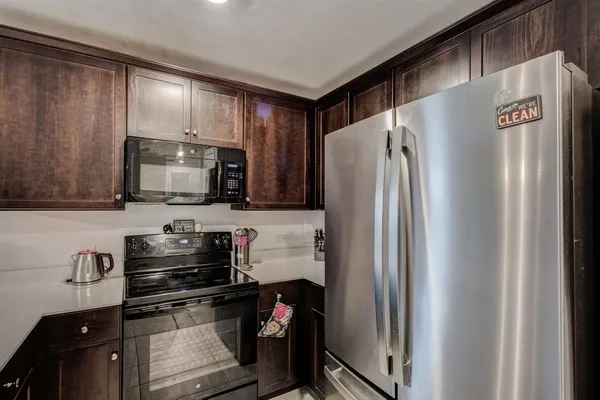 a kitchen with stainless steel appliances a refrigerator stove and microwave