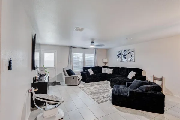 a living room with furniture and wooden floor