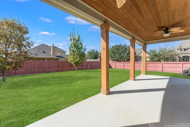a view of a house with a backyard
